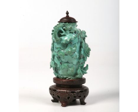 A Chinese Qing dynasty miniature turquoise jar with hardwood cover and raised on a hardwood plinth with silver wire inlay. Ca