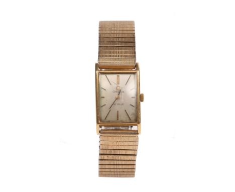 A gentleman's Omega de Ville 18 carat gold manual bracelet watch on gold plated expanding strap. With rectangular satin dial 