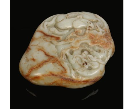 A Chinese celadon jade boulder with russet suffusions. Carved in relief with a horse and a dragon, 12cm.Condition report inte