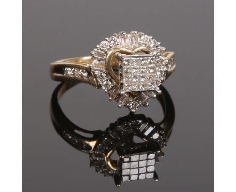 A 14 carat gold and diamond ring. Set with a panel of sixteen princess cut diamonds under a heart shaped halo of baguette and