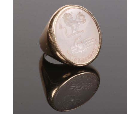 A 19th century gentleman's yellow metal seal ring. Set with a large ovoid carnelian tablet carved with a rampant lion over a 