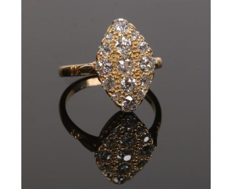 An 18 carat gold and diamond navette shaped panel ring. Set with fifteen old European cut diamonds&nbsp;on a bead textured gr