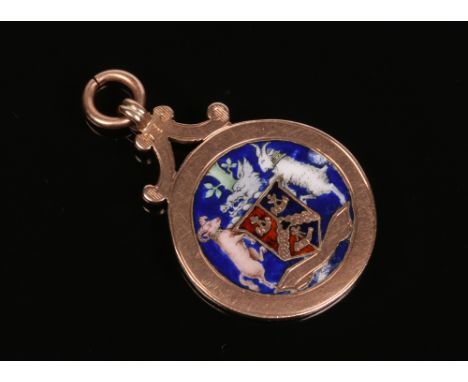 A 9 carat gold enamelled medal fob decorated with a coat of arms, 9.2 grams.&nbsp;Condition report intended as a guide only.S