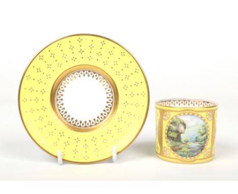 A Lynton Porcelain Company coffee can and saucer by Stefan D. Nowacki. Gilded and jeweled on a yellow and gold ground, painte