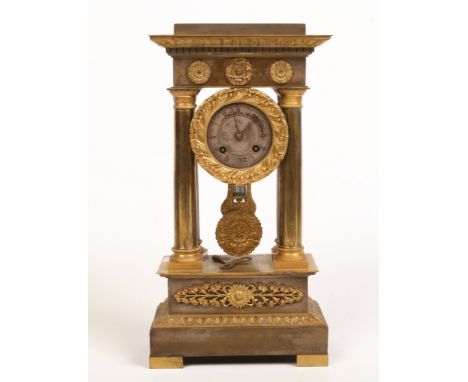 A 19th century French gilt and silvered metal portico clock. With cylindrical 8 day movement striking on a bell and signed J.