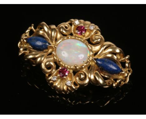 An 18 carat gold brooch of lozenge form. Set with a large ovoid opal surrounded by lapis lazuli, rubies and diamonds, 9.5 gra