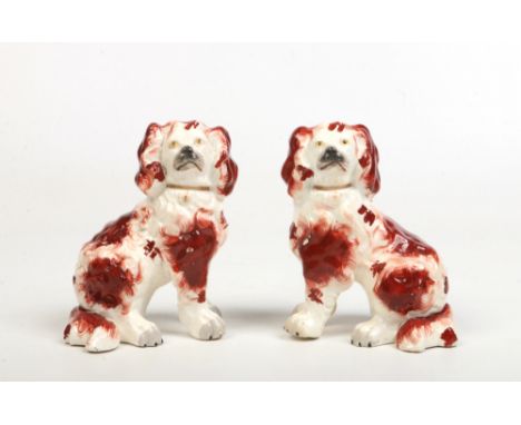 A pair of 19th century Staffordshire spaniels. Coloured in enamels and with separately moulded front legs, 14cm.Condition rep