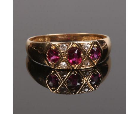 An 18 carat gold ruby and diamond ring. Set with three ovoid rubies on triangular panels of diamonds. Assayed Birmingham 1900