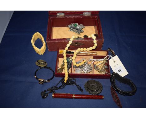Whitby and French jet, to include; brooches; crucifix; earrings; a gilt metal and black enamel memorium brooch the centre wit