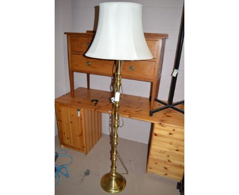 A modern brass standard lamp cream silk shade.