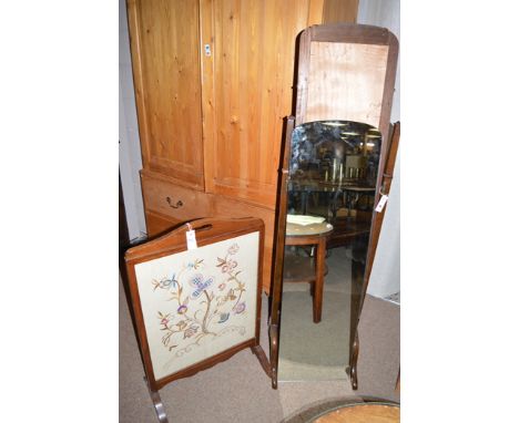 An early 20th Century oak cheval mirror; together with a mahogany framed needlework firescreen.