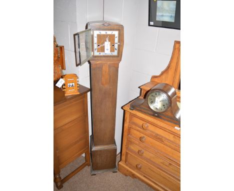 An grandmother clock in oak case; a mantel clock in oak case; and an early 20th Century desk top calendar.  (3)