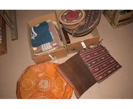 Tribal items to include: a leather pouffe cover, woven baskets, carved ornament of an elephant, hand-woven cushion covers, ta