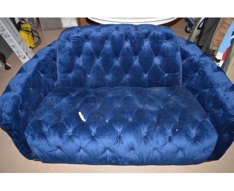 An Art Deco style two-seater settee button back seat, back and arms, in blue velour.