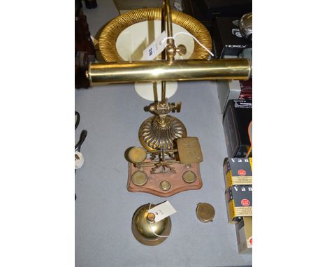 An early 20th Century brass desk lamp; a set of postal scales; a table bell; a compass; together with a Marks & Spencer fruit