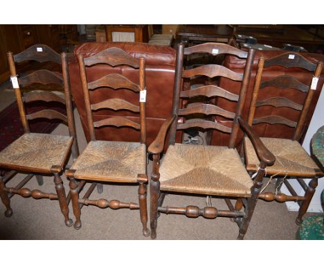 Three 19th Century oak ladder back dining chairs; and one carver, rushwork seats.