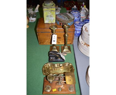 An oak box; a pair of 19th Century brass candlesticks with push action; a brass candle snuffer on tray; a pair of postal scal