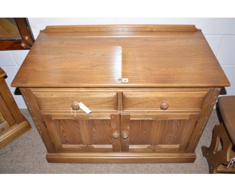 A dark stained elm Ercol side cabinet, fitted two drawers and two cupboard doors, 96cms wide.