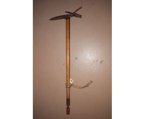 An early 20th Century Marke Mischabel mountaineers ice axe with serrated pick and brown leather cover stamped 'Made in Switze