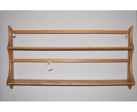 An Ercol elm wall hanging shelf unit.