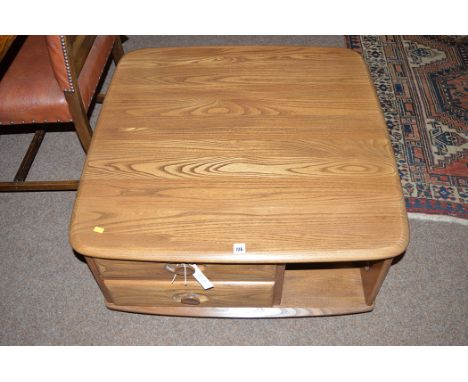 A dark stained elm Ercol coffee table, fitted an alcove and two drawers, 80cms square.