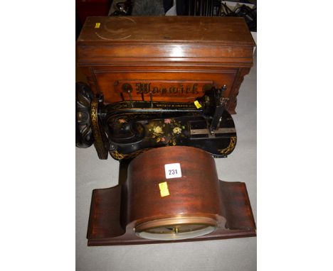 A Victorian sewing machine 'The Warwick Patent', in mahogany box; and a 20th Century mahogany mantel clock.