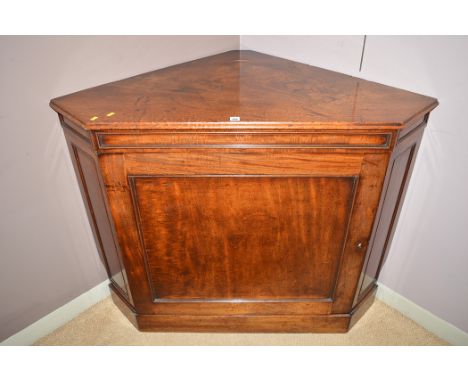 A Georgian mahogany corner cabinet, the single panel door opening to reveal a shelf, 117cm wide.