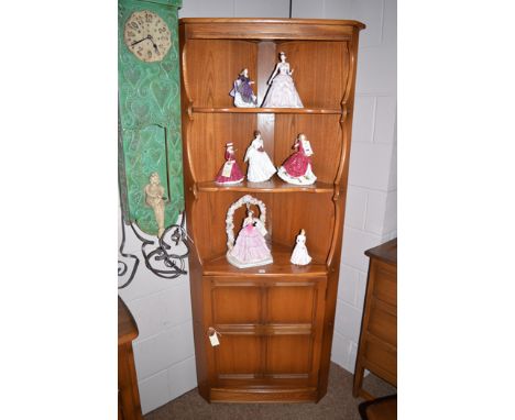 An Ercol dark stained elm corner display cabinet.