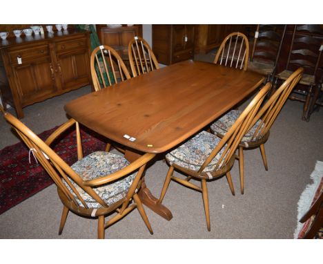 Ercol: an elm refectory style dining table, 152cms long; together with six associated Ercol Quaker Windsor dining chairs, fou