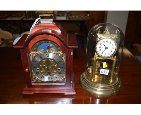 A 20th Century eight-day chiming mantel clock in mahogany case; and a brass perpetual motion clock in architectural frame, co