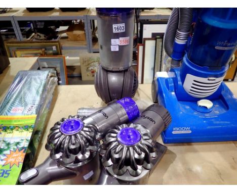 Dyson DL 50 vacuum cleaner and wo Dyson V6 trigger handheld cleaners. All electrical items in this lot have been PAT tested f