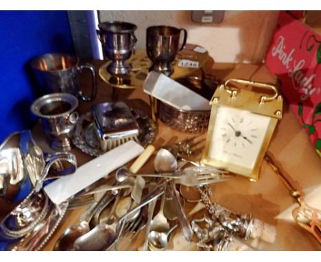 Mixed metalware including brass trivet, wine bottle stoppers, loose silver plated cutlery and a brass carriage clock. Not ava