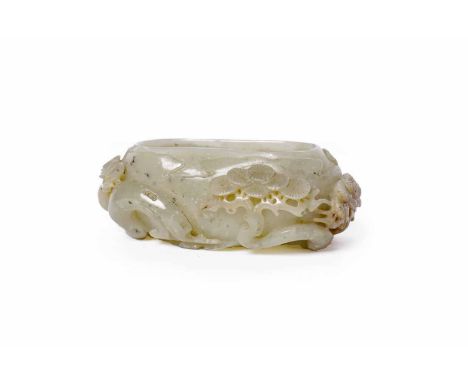 EARLY 20TH CENTURY CHINESE JADE BRUSH POT carved in relief with tree designs, 11.5cm long 