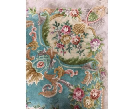 LARGE CHINESE WOOL CARPET with floral designs on a turquoise ground, with fringed edge, 5.5m x 3.6m 