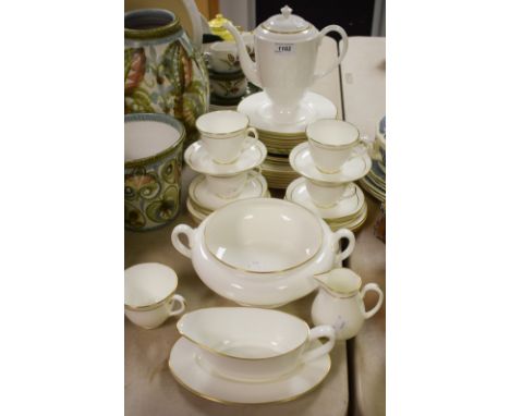 A Royal Worcester Strathmore pattern dinner service comprising six dinner plates, side plates, tea plates, five cups, six sau