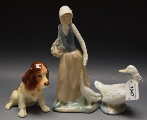 A Nao figure of a young lady feeding a goose; a Nao goose (damaged beak); a Sylvac figure of a seated spaniel (3)