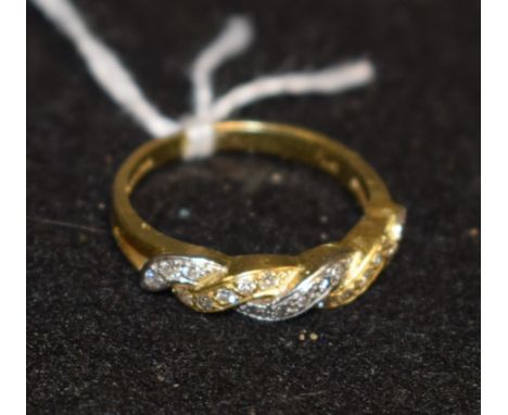 A diamond encrusted two colour twisting ring, yellow and white gold intertwining crest encrusted with twenty one diamond acce