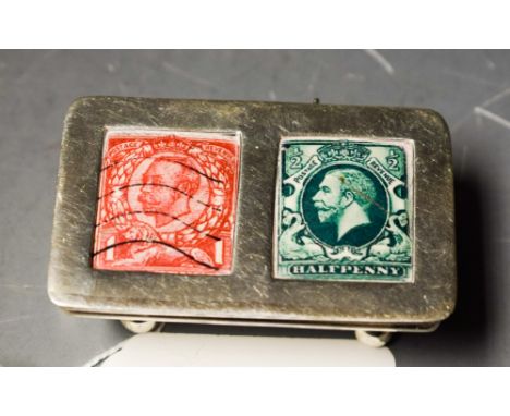 An Edwardian style sterling silver stamp case, cover with enamel panels, resting on four bun feet, 5.5cm wide