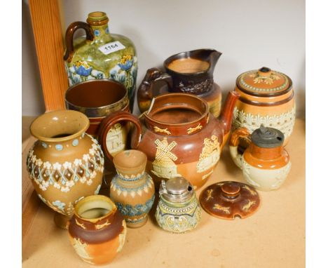 A Doulton Lambeth handled liquor flask, Art Nouveau blue poppy decoration; others, a silver rimmed stoneware tankard, tobacco