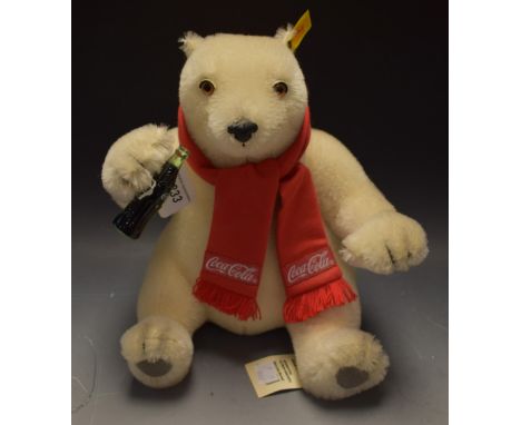 Steiff - a Coca-Cola Polar Bear, No 654831, white body, glass eyes, red scarf, cola bottle to paw, modelled seated, yellow ea