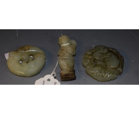 A Chinese carved jade roundel, horse and ape, 5.5cm diameter; others, mermaid, deity (3)