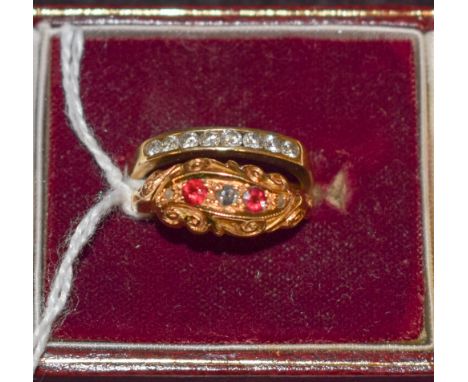 An 18ct gold five stone diamond and ruby chip ring, 2.9g; a 9ct gold channel set diamnd half eternity ring, 1.7g (2)