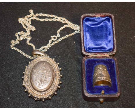 A Victorian silver lady's locket, hinged cover engraved and chased with country flowers, beaded outer-border, enclosing a pai