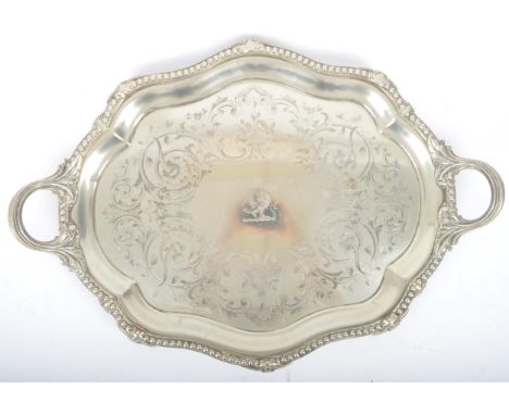 An oversized 19th century large silver plated salver tray. The tray being raised on s-scroll terminal feet with a heavy beade