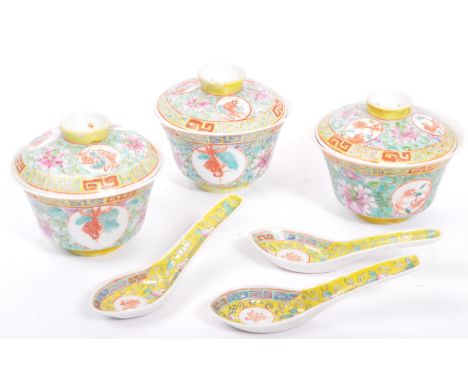 A collection of vintage 20th century Chinese Asian rice bowls with lids and spoons. In the Famille rose pattern with painted 