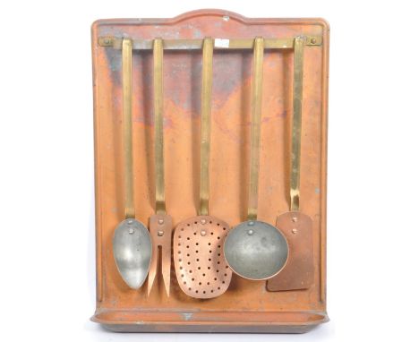 Early 20th century French copper wall utensil holder. With a rectangular back, metal arm holder, with drip tray to lower. Wit