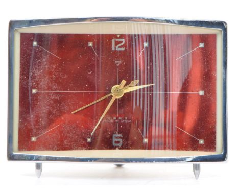 A retro mid 20th century clock Chinese mantel table clock. Of rectangular form with red metallic ground and chrome surroundin