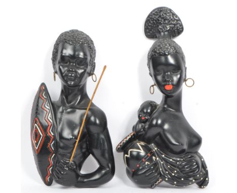 Two vintage 20th century African tribal plaster wall figurine plaques. Depicting a nude female holding a vase and young boy t