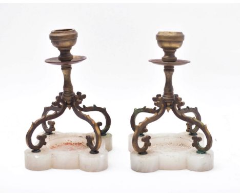 A pair of early 20th century brass &amp; onyx base table desk candlestick holders. Each candlestick having scrolled quadruple