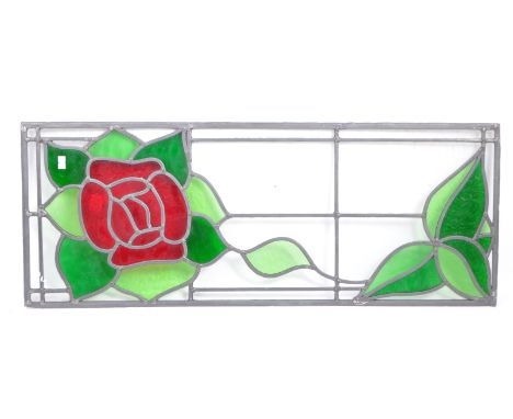 A vintage 20th century stain glass window panel. Having lead panels with rose flower decoration in the green and red colourwa